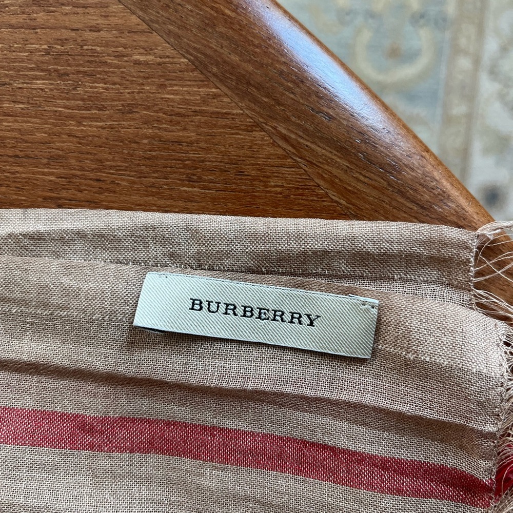 The iconic Burberry scarf. Measurements 28 by  84 inches.